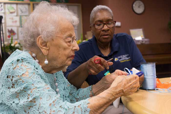 Resident and caretaker doing crafts