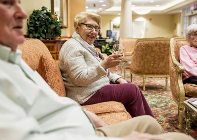 Senior living residents socializing with drinks