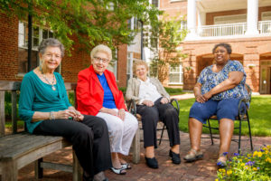 Grand Oaks senior living residents socializing together outdoors