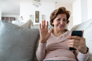 senior woman connecting with her loved ones via facetime