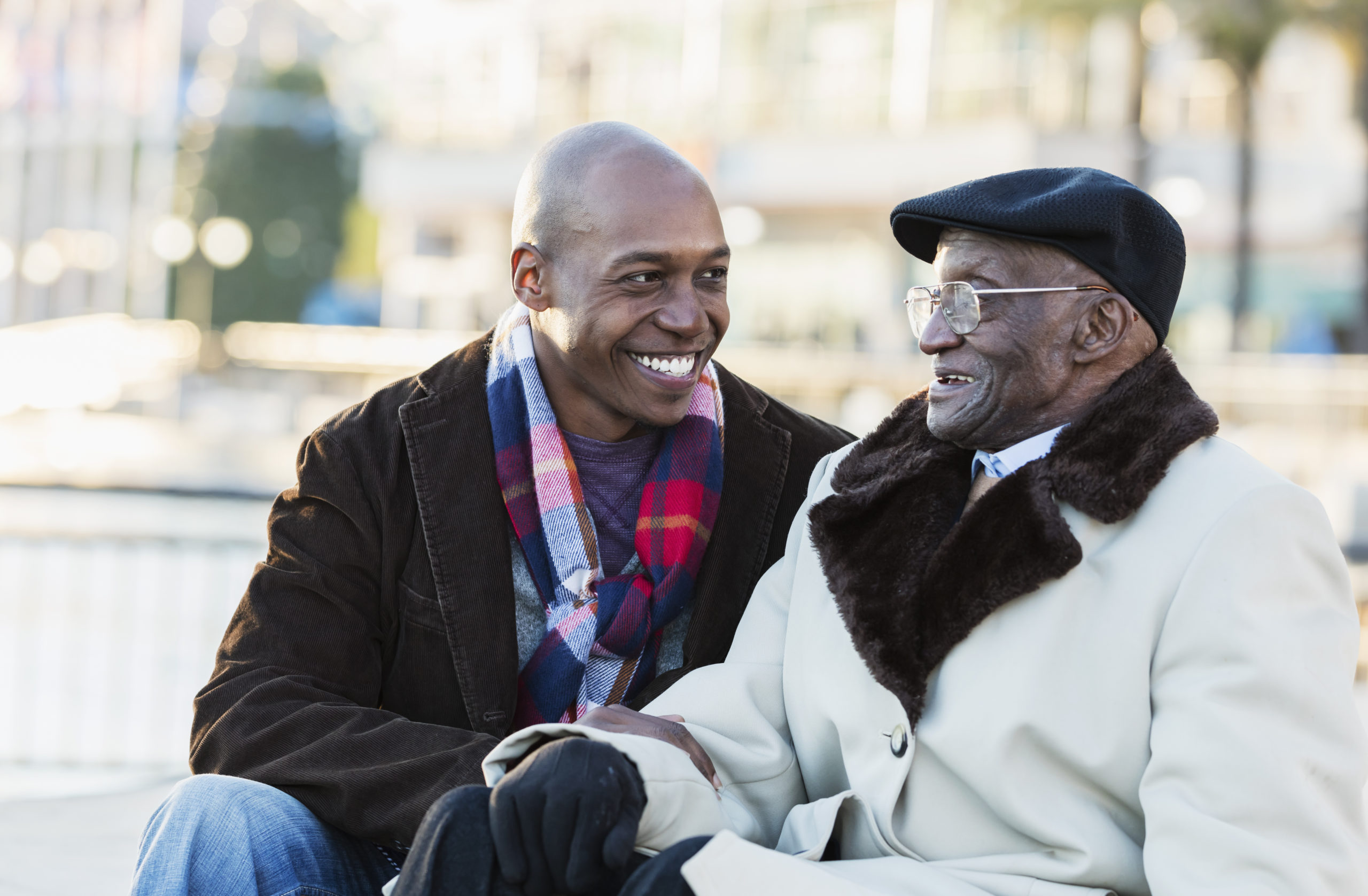 African-American man with grandfather In city