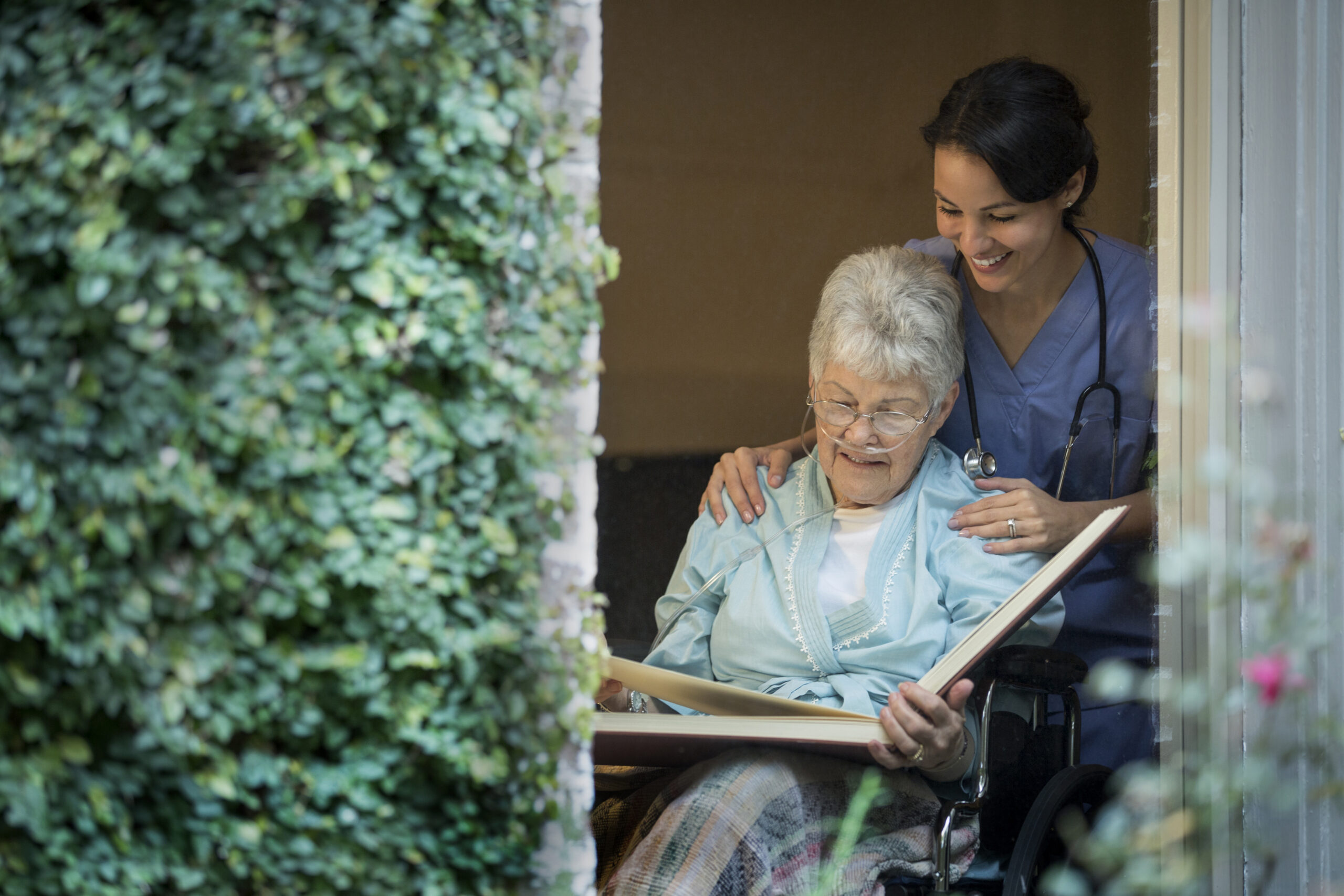 elderly woman and nurse looking at photos