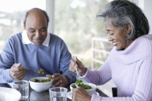 Senior couple eating salad